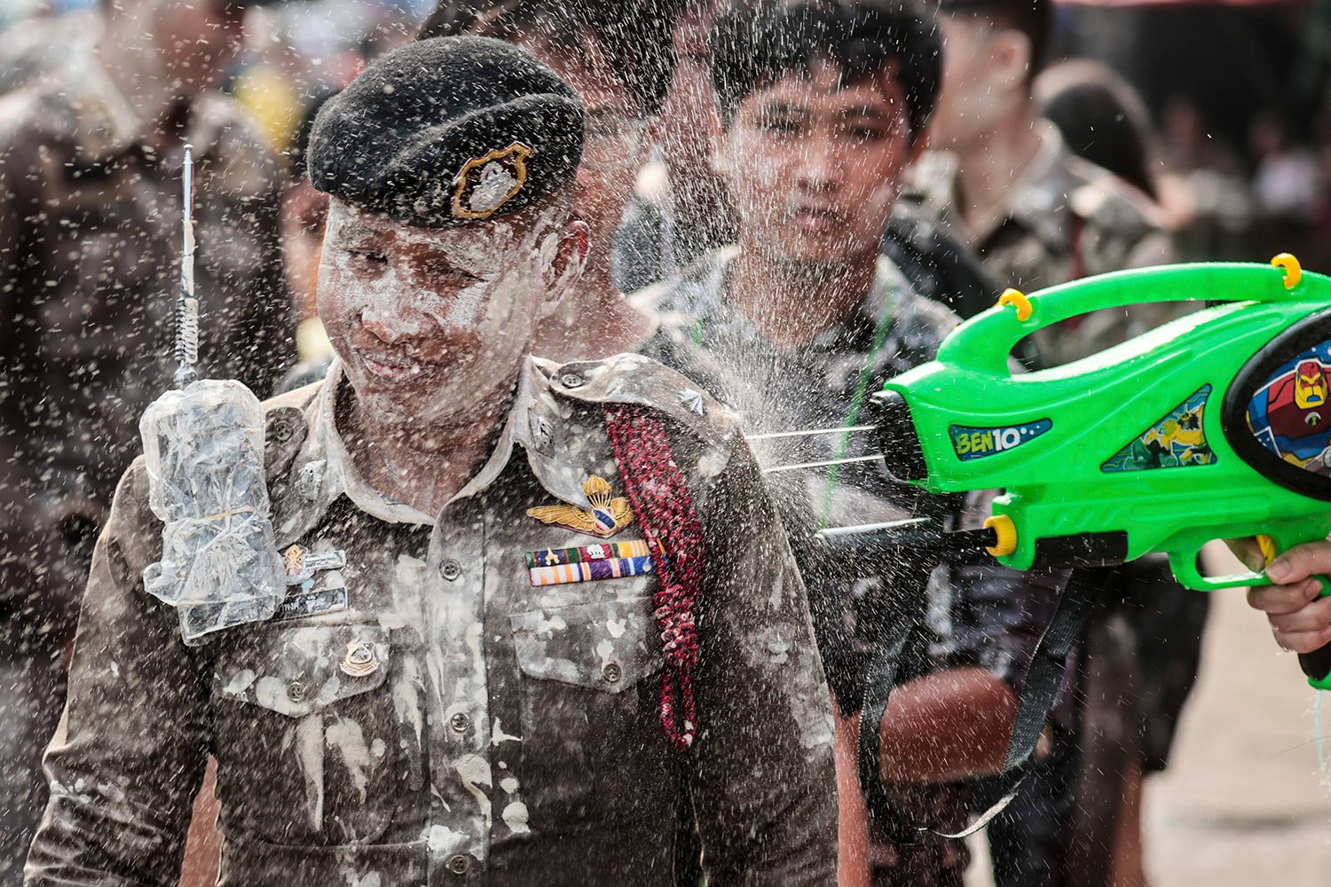  A man sprays water at a policeman to celebrate Songkran festival in Prachinburi Province, east of Bangkok. Thursday, April 13, 2023. (AP Photo/Wason Wanichakorn) 