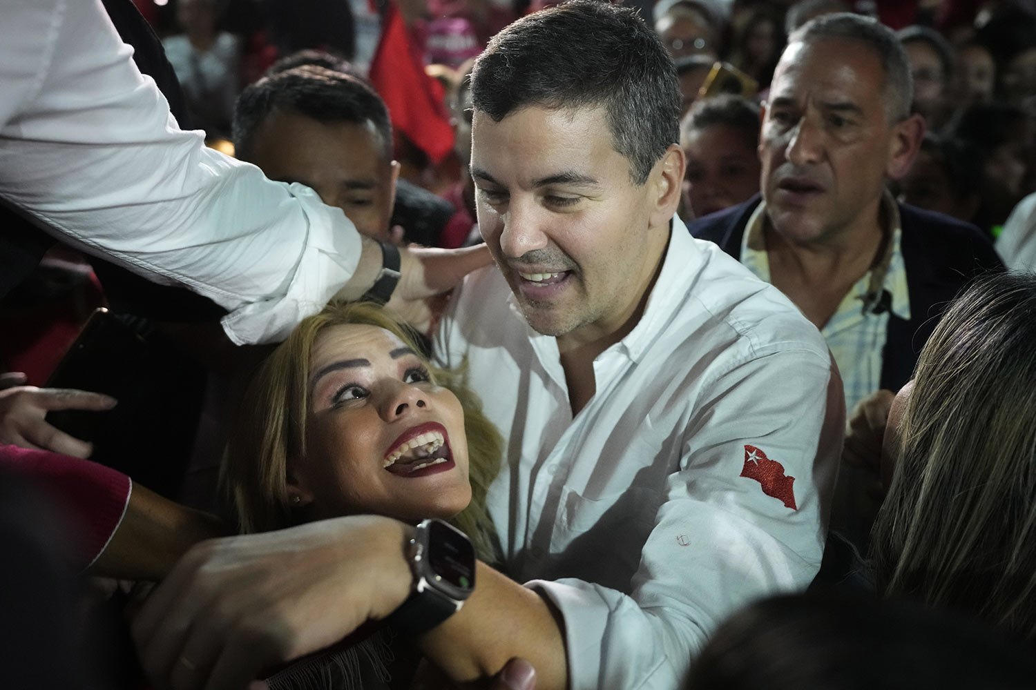  Santiago Peña, presidential candidate for the ruling Colorado Party, greets a supporter as he arrives to his campaign rally in Villa Elisa, Paraguay, April 26, 2023. Pena won the election on April 30. (AP Photo/Jorge Saenz) 