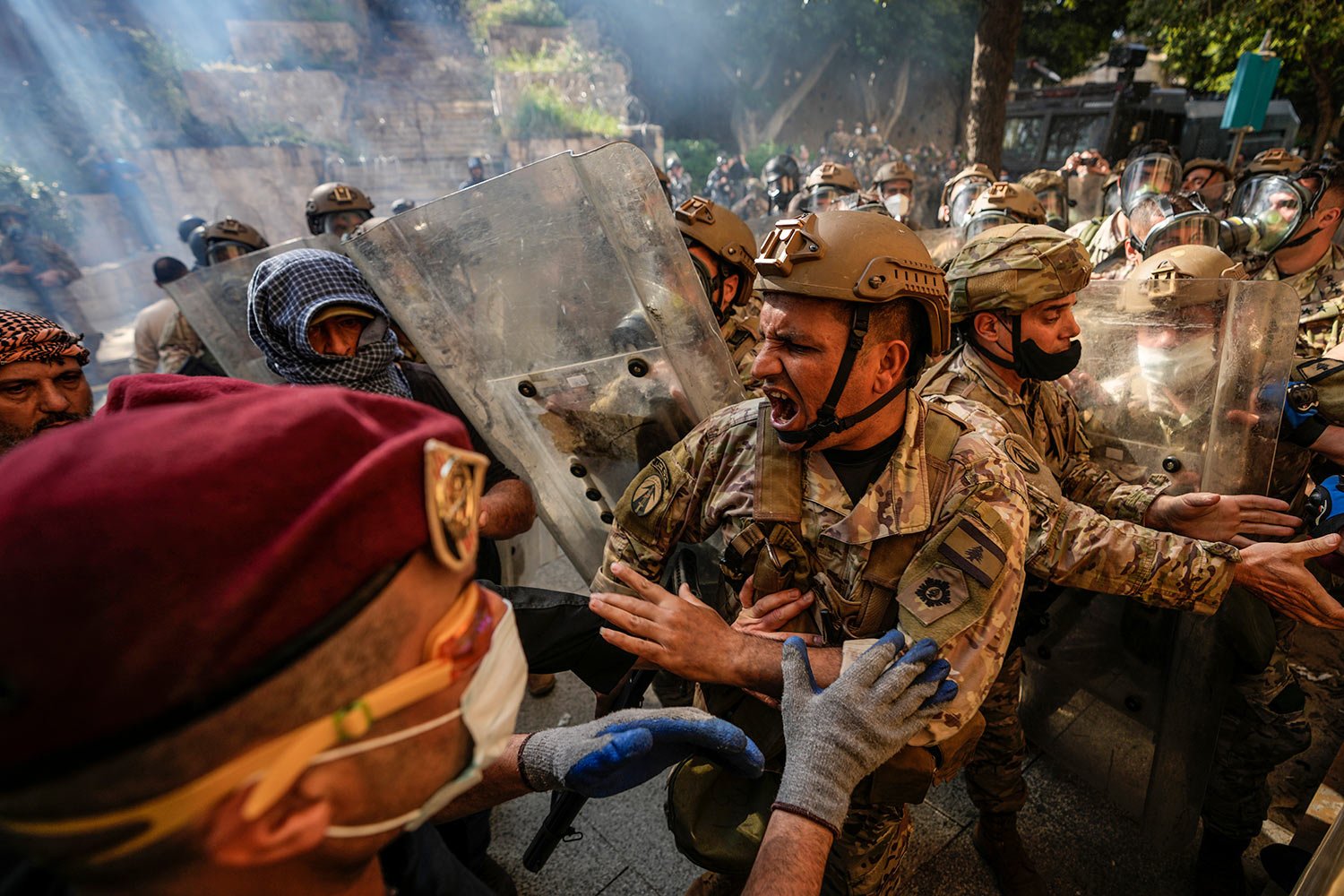  Retired members of the Lebanese security forces and other protesters scuffle with the Lebanese army after they removed a barbed-wire barrier in order to advance towards government buildings during a protest in Beirut, Lebanon, Tuesday, April 18, 202
