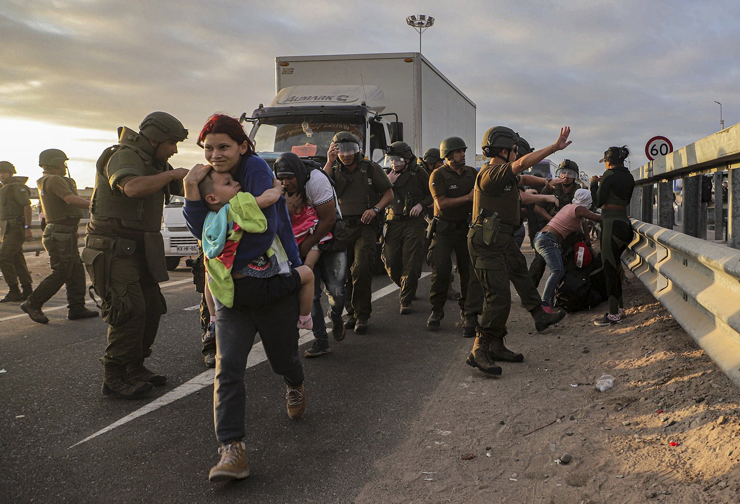  Migrants who blocked the highway on the Chile-Peru border are dispersed by Chilean police near Arica, Chile, May 2, 2023. A migration crisis at the border has intensified as migrants are unable to enter Peru. (AP Photo/Agustin Mercado) 