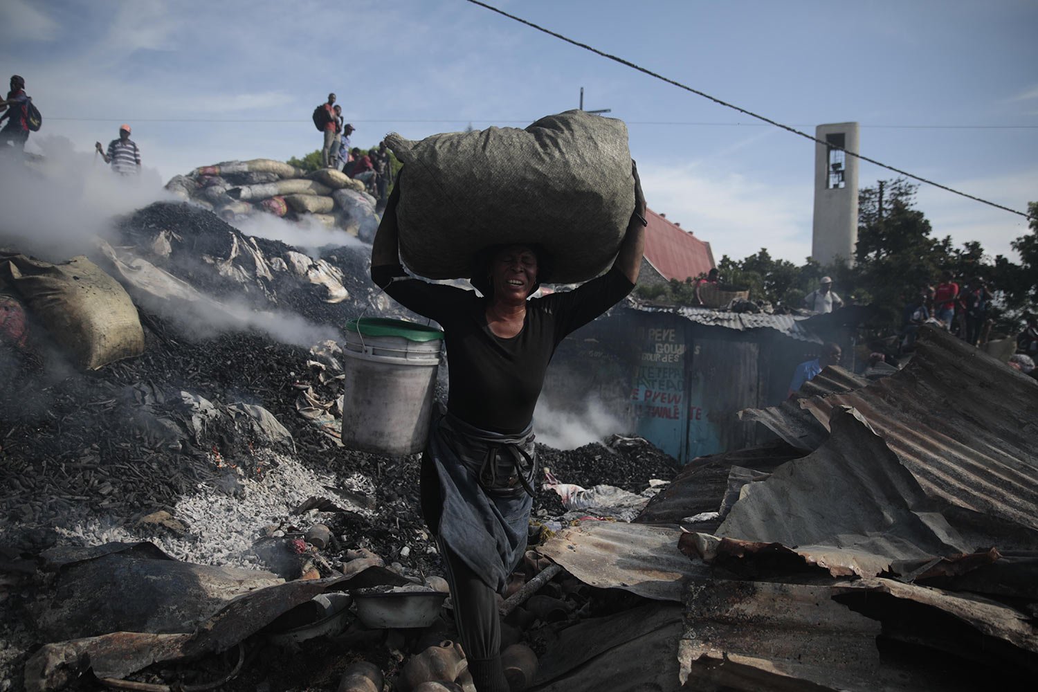  A vendor salvages items from the burned ruins of the Shada Market in the Petion-ville area of Port-au-Prince, Haiti, May 4, 2023. (AP Photo/Odelyn Joseph) 