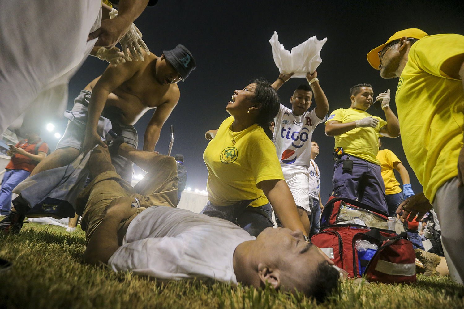  Rescuers treat an injured fan on the field of Cuscatlan stadium in San Salvador, May 20, 2023. At least nine people were killed and dozens injured when stampeding fans pushed through one of the access gates at a quarterfinal Salvadoran league soccer