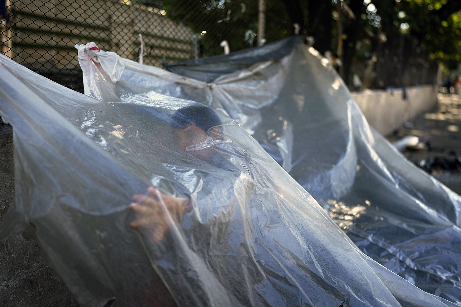  Pablo Fernandez, an Mb'a Indigenous man from Caaguazu, stands under plastic at an encampment outside the National Indigenous Office (INDI) where an Indigenous group is demanding food aid in Asuncion, Paraguay, April 28, 2023. (AP Photo/Jorge Saenz) 