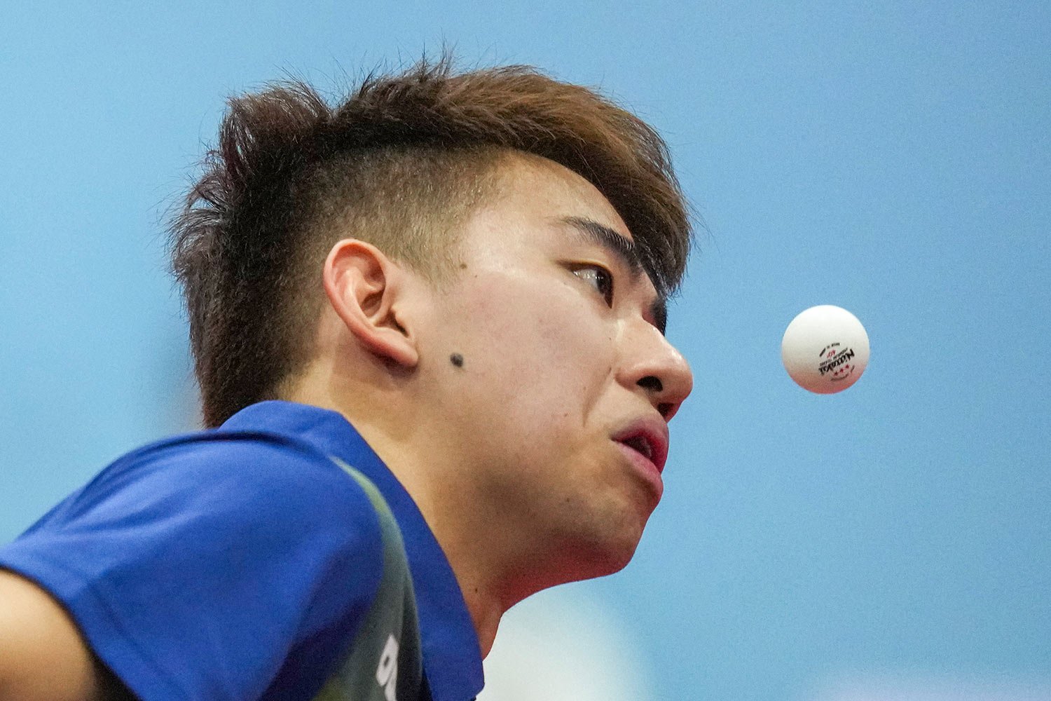 Singapore's Koen Yew Enpang keeps his eyes on the ball during his men's doubles semi final table tennis match against Philippine's Richard Pugoy Gonzales and John Russel Picondo at the 32nd Southeast Asian Games in Phnom Penh, Cambodia, Sunday, May 