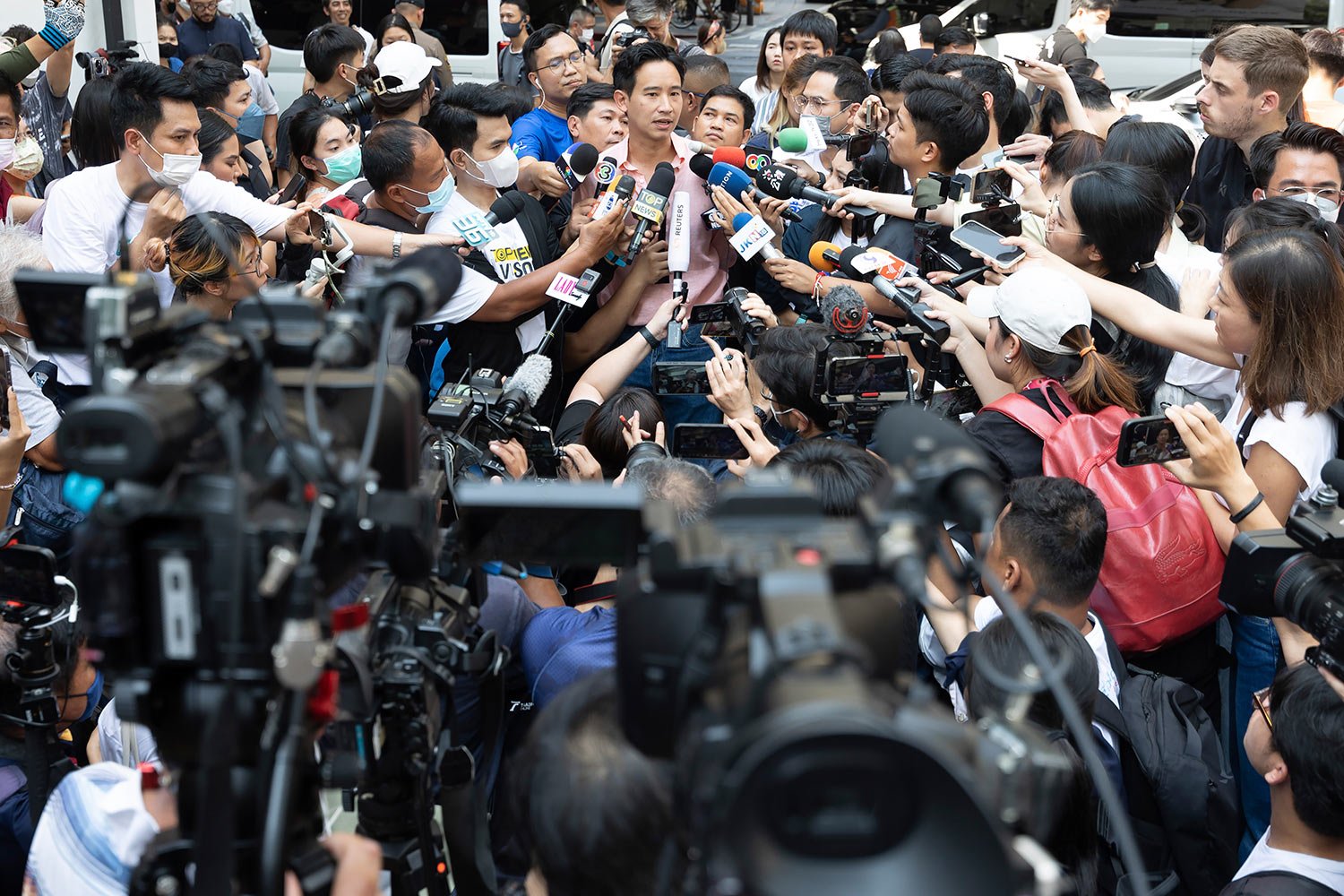 Leader of Move Forward Party Pita Limjaroenrat, rear center, talks to media after casting his vote during a general election at a polling station in Bangkok, Thailand, Sunday, May 14, 2023.  (AP Photo/Rapeephat Sitichailapa) 