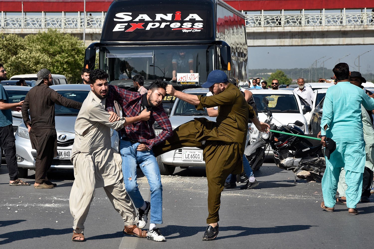  Plainclothes police officers beat a supporter of Pakistan's former Prime Minister Imran Khan during a protest to condemn the arrest of their leader in Peshawar, Pakistan, Tuesday, May 9, 2023. (AP Photo/W.K. Yousufzai) 