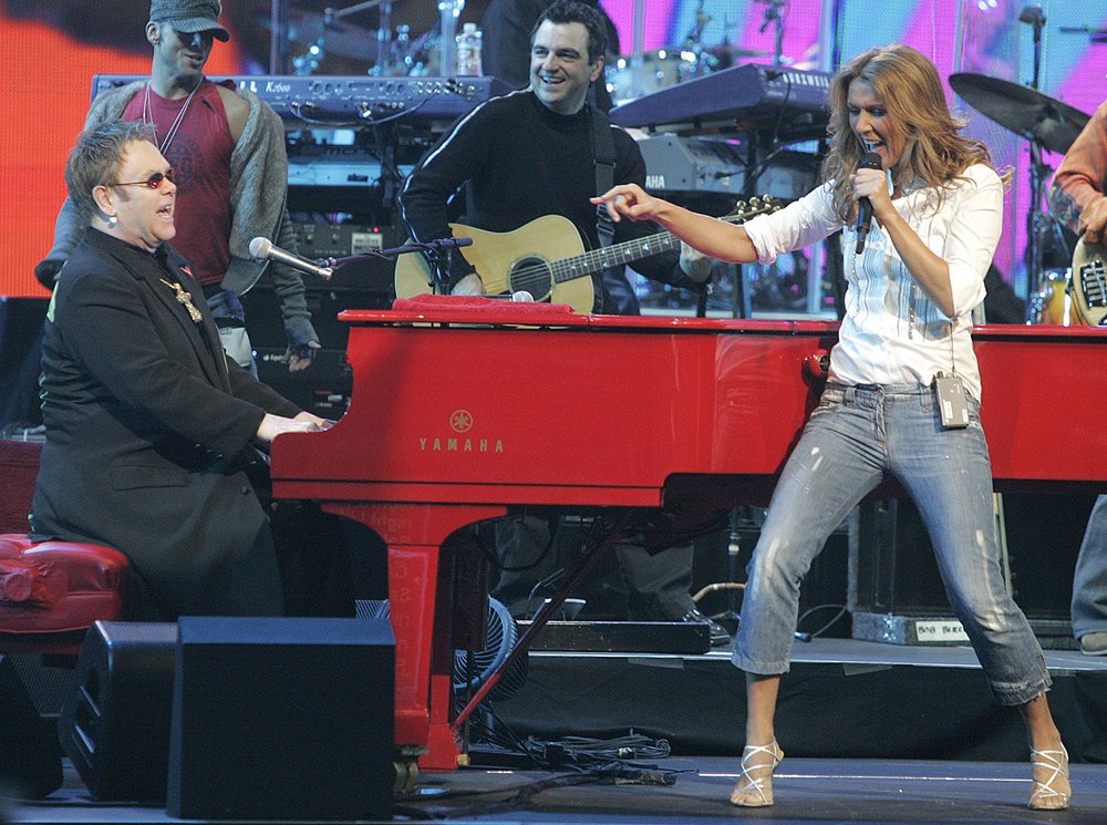  Elton John, left, and Celine Dion, right,  perform together for the first time at Caesars Palace hotel-casino in Las Vegas on Monday, Feb. 20, 2006, to raise funds for the hurricane-affected employees of Harrah's Entertainment Inc. The concert raise
