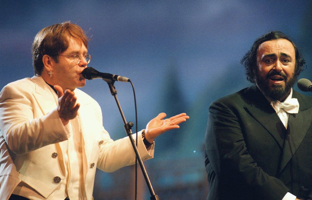  Italian tenor Luciano Pavarotti and British rock star Elton John, left, sing together at the "Pavarotti &amp; Friends for War Children" charity concert in Modena, Thursday June 20, 1996.   (AP Photo/Renato Ferrini) 