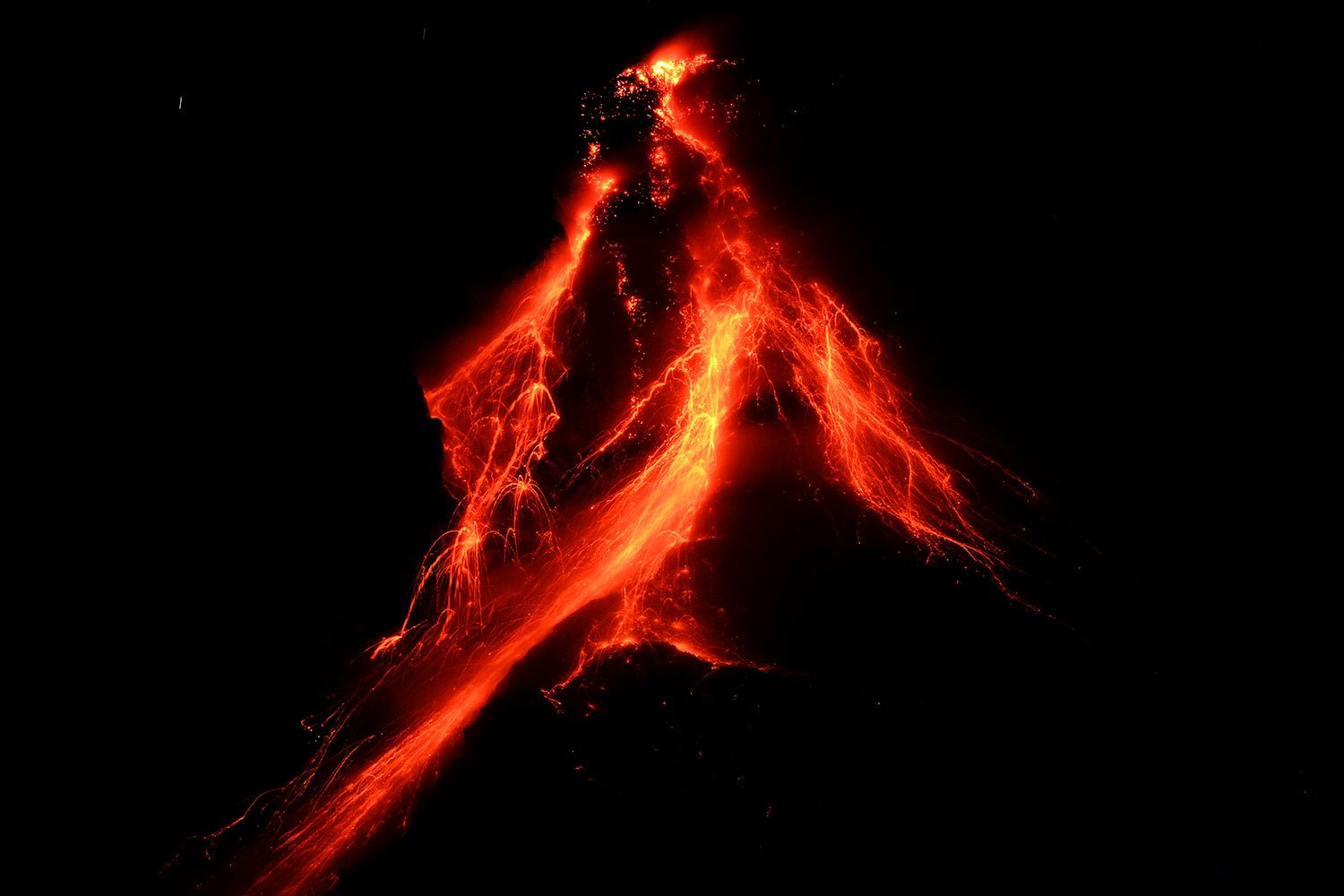 Lava flows down the slopes of Mayon volcano as seen from Daraga town, Albay province, northeastern Philippines, Tuesday, June 13, 2023. (AP Photo/Aaron Favila)