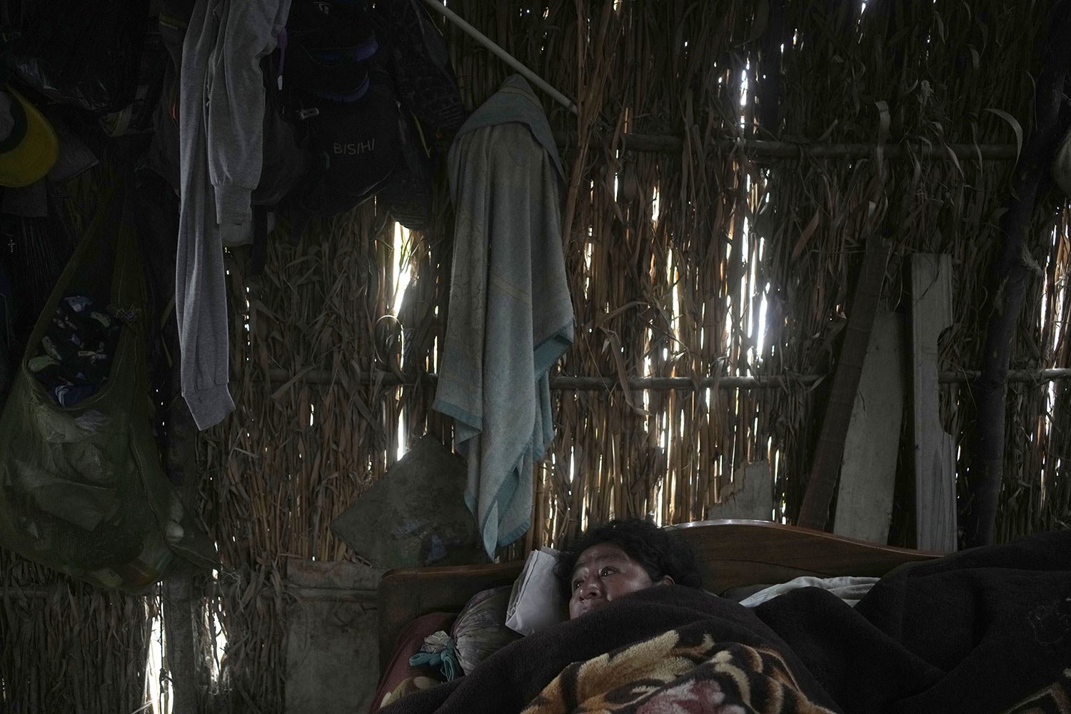 Dengue patients Maria Galan, 47, lies in her bed at the San Pablo low-income neighborhood in Piura, Peru, June 4, 2023. Dengue, a viral disease transmitted by a mosquito, causes flu-like symptoms, such as muscle pain and fever. (AP Photo/Martin Meji