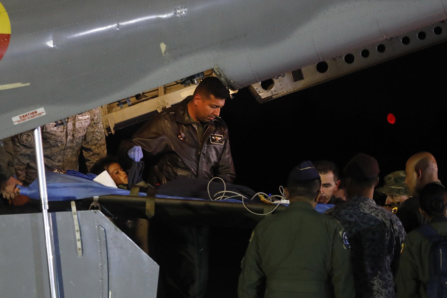  Military personnel unload from a plane one of four Indigenous children who were missing after a deadly plane crash at the military air base in Bogota, Colombia, June 10, 2023. The children survived a small plane crash 40 days ago and had been the su