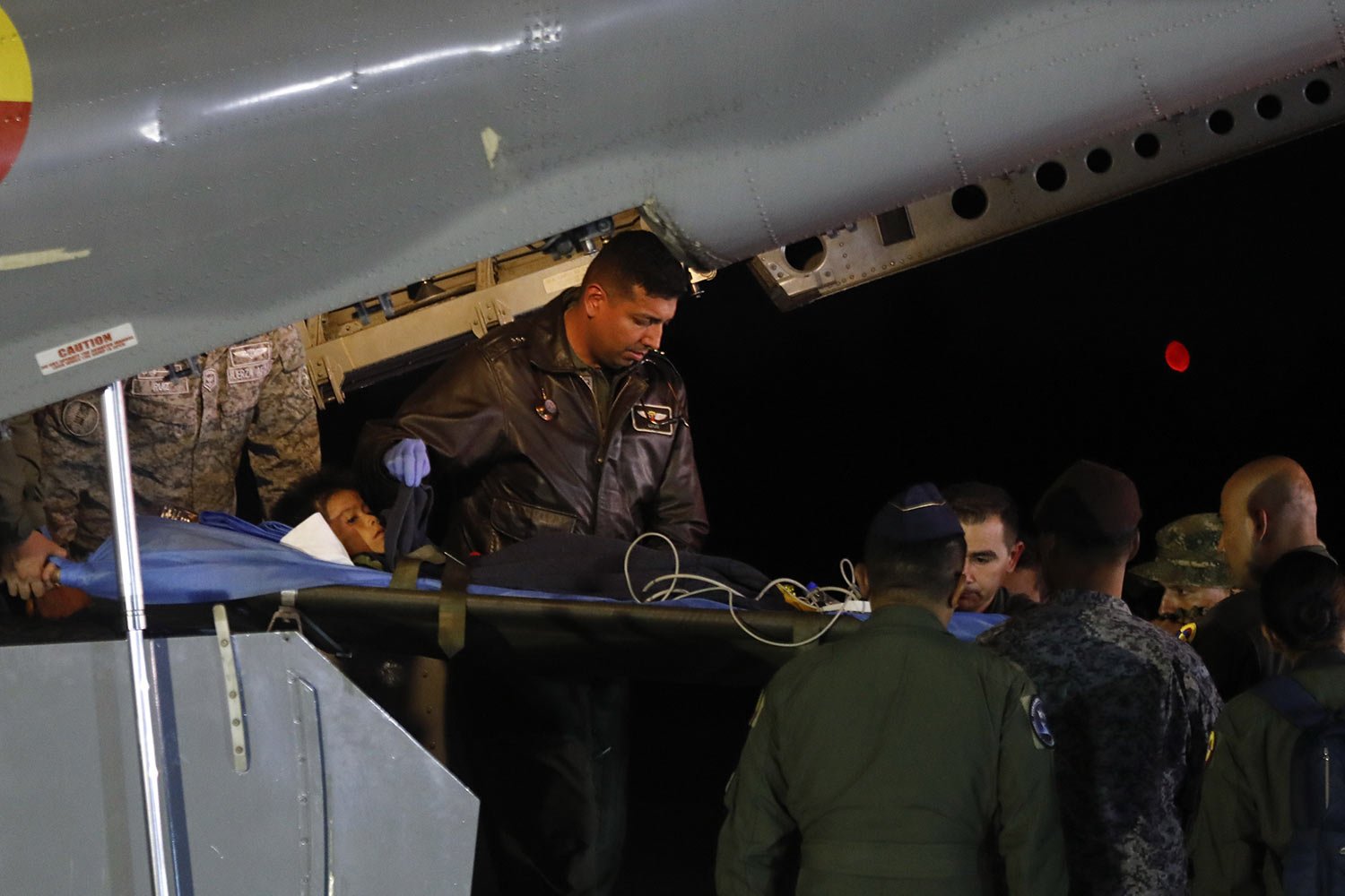Military personnel unload from a plane one of four Indigenous children who were missing after a deadly plane crash at the military air base in Bogota, Colombia, June 10, 2023. The children survived a small plane crash 40 days ago and had been the su