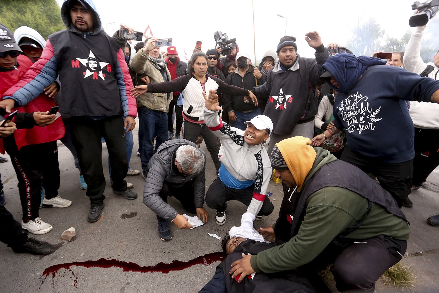  Protesters assist a demonstrator injured during clashes between police and protesters, in San Salvador de Jujuy, Argentina, June 20, 2023. Protests have erupted throughout the province in response to a recently approved provincial constitutional ref