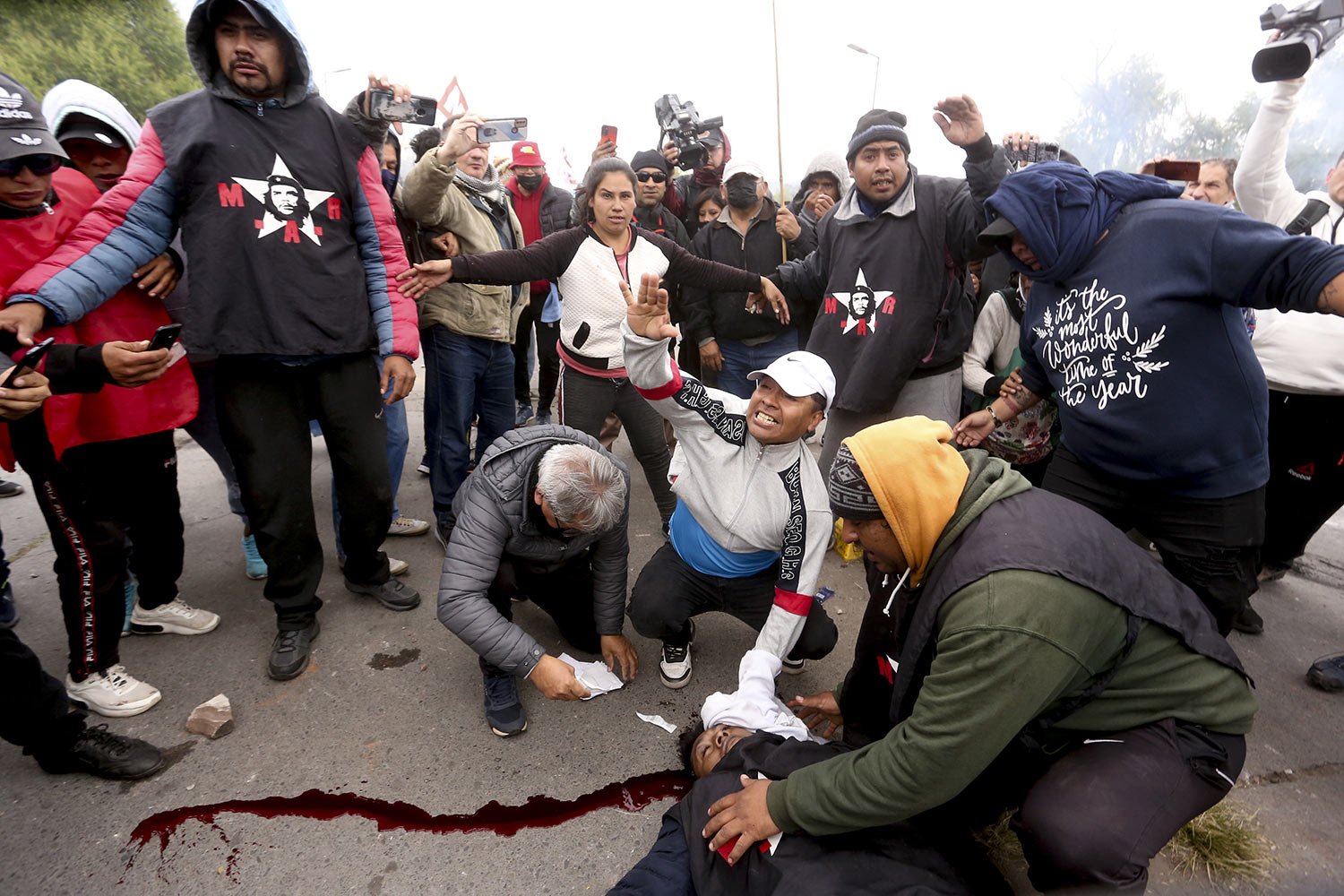 Protesters assist a demonstrator injured during clashes between police and protesters, in San Salvador de Jujuy, Argentina, June 20, 2023. Protests have erupted throughout the province in response to a recently approved provincial constitutional ref