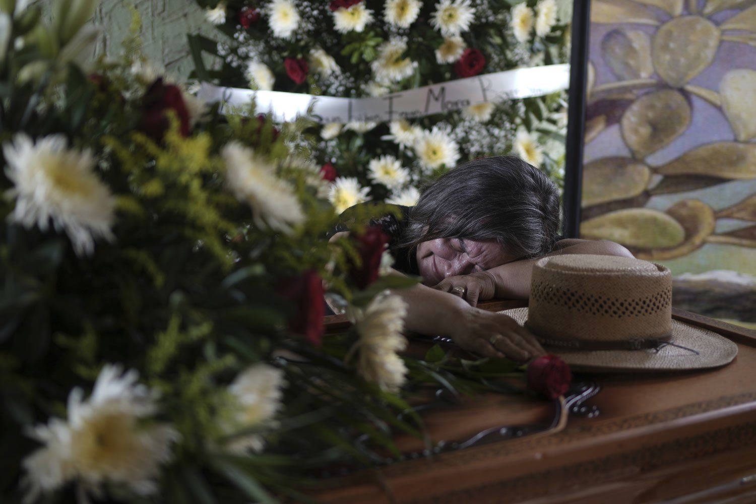 Olivia Mora cries over the casket of her brother Hipolito Mora during his wake at his home in La Ruana, Mexico, June 30, 2023. Hipolito Mora, the leader of an armed civilian movement that once drove a drug cartel out of the western state of Michoaca