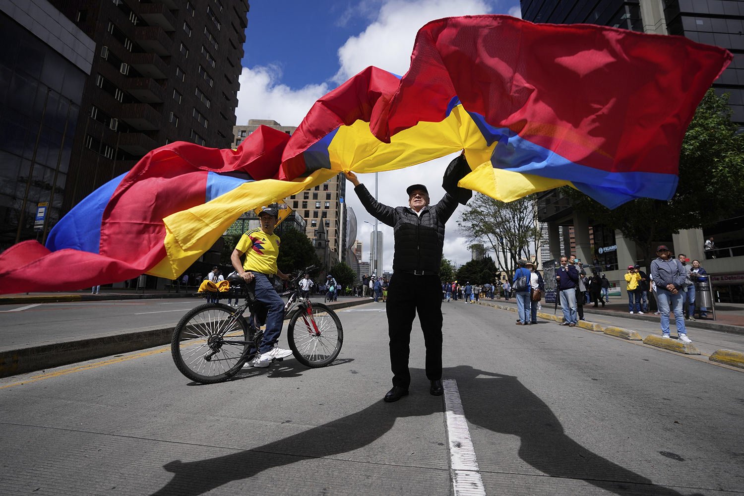  A protester waves a national flag during a march against the government’s reforms to the nation's healthcare system, pensions and labor, in Bolivar square in Bogota, Colombia, June 20, 2023. (AP Photo/Fernando Vergara) 