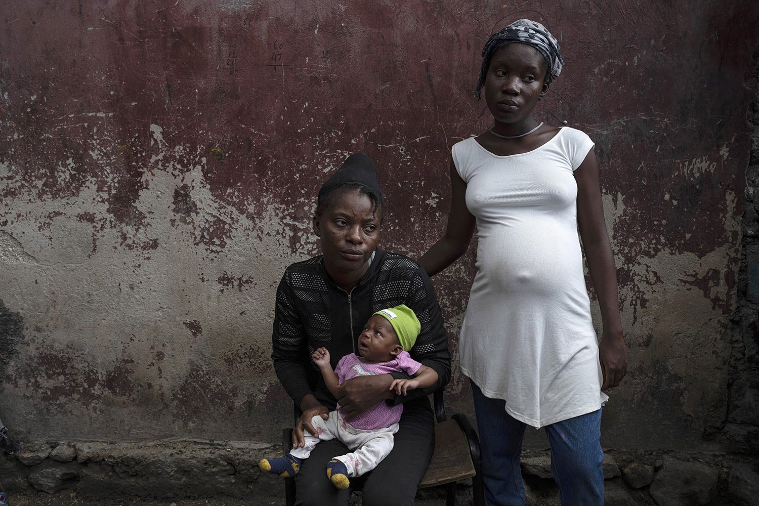  Januelle Datka, her baby girl Princess and her 15-year-old daughter Titti, pose for a photo at a makeshift shelter in Jean-Kere Almicar's front yard, in Port-au-Prince, Haiti, Sunday, June 4, 2023. Both mother and daughter said they were raped by ga