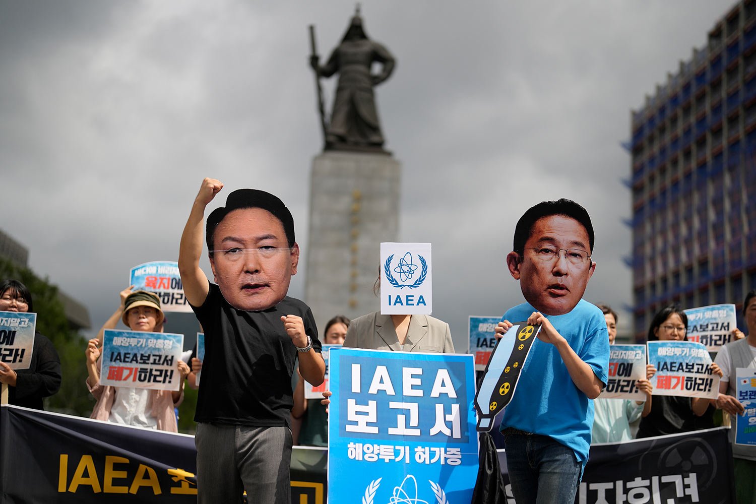 Members of civic groups wearing masks of Japanese Prime Minister Fumio Kishida, right, and South Korean President Yoon Suk Yeol pose during a rally to oppose Japanese government's decision to release treated radioactive water into the sea from the F