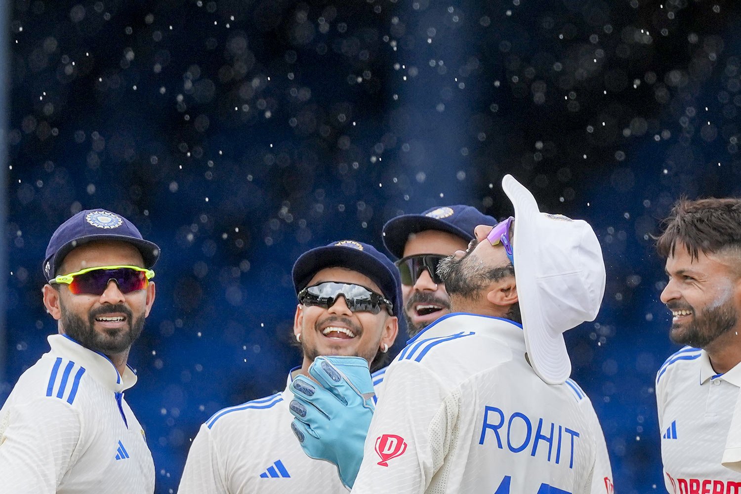  India's captain Rohit Sharma and teammates celebrate the dismissal of West Indies' Kirk McKenzie as rains breaks on day three of their second cricket Test match, at Queen's Park in Port of Spain, Trinidad and Tobago, Saturday, July 22, 2023. (AP Pho
