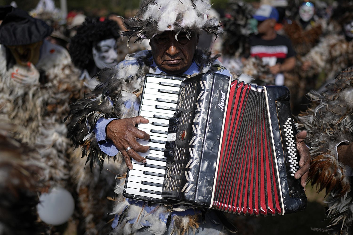  A musician dressed in a feathered costume pays tribute to Saint Francisco Solano for a fulfilled prayer during a procession in his honor in Emboscada, Paraguay, Monday, July 24, 2023. Legend has it that while lying on his death bed in a Peruvian con