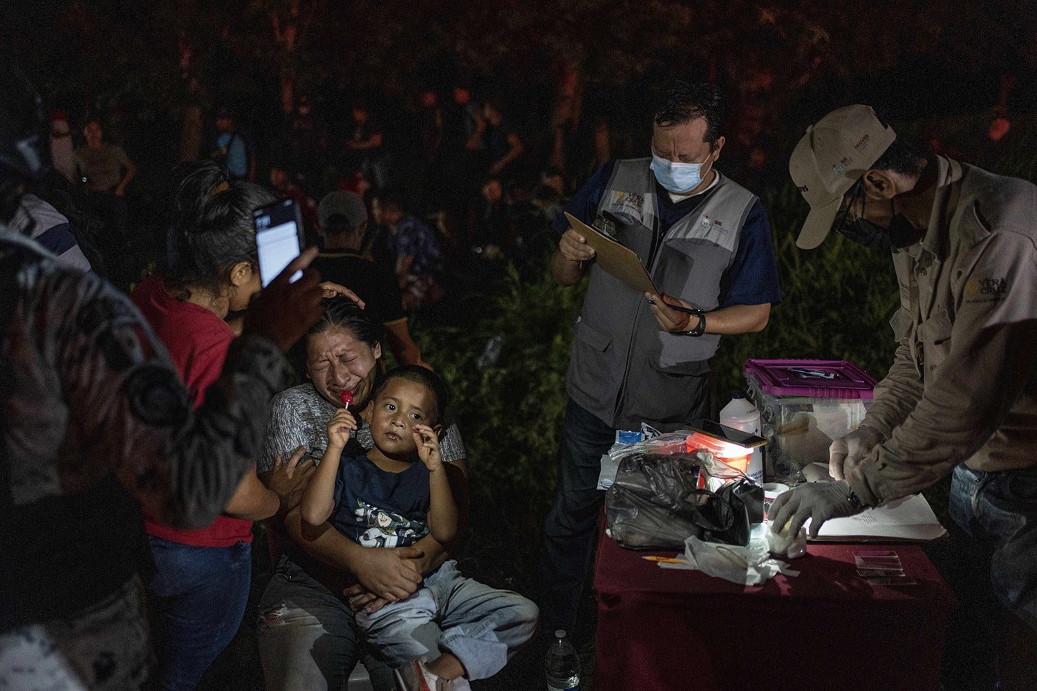  Migrants, mainly from Central America, who were traveling to the U.S. inside a tractor-trailer, are detained by Mexican immigration agents and National Guard members, in Veracruz, Mexico, Sunday, July 23, 2023. (AP Photo/Felix Marquez) 