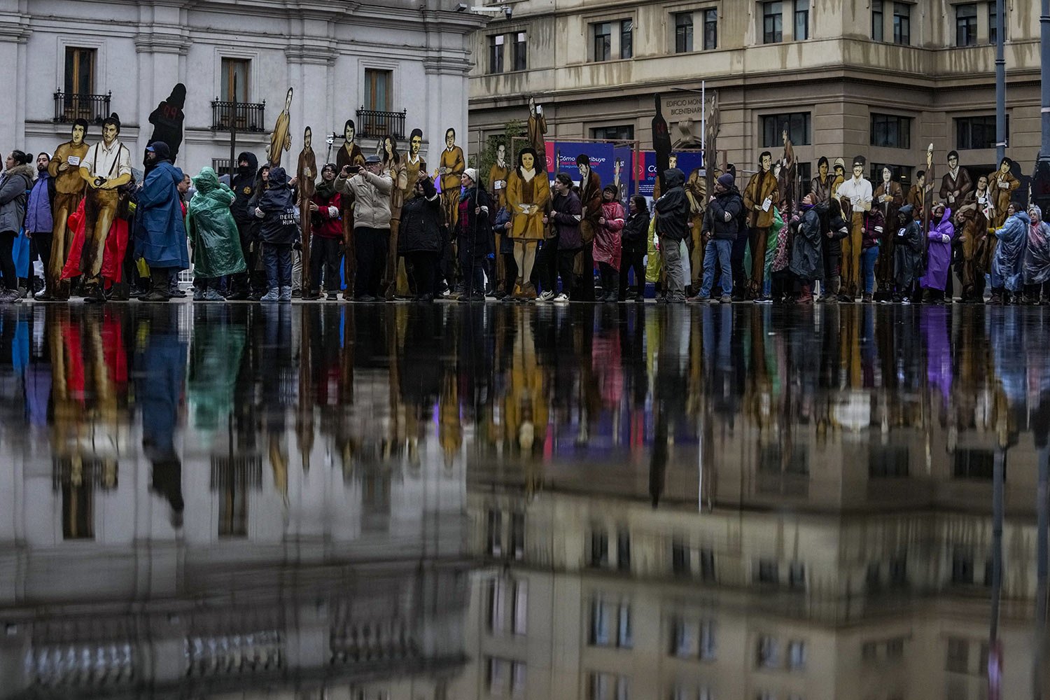  Members of the Disappeared Detainees Relatives Group of Chile hold cardboard cutouts depicting their disappeared relatives in a march commemorating the so-called "Operation Colombo” in which over a hundred dissidents were executed by Augusto Pinoche