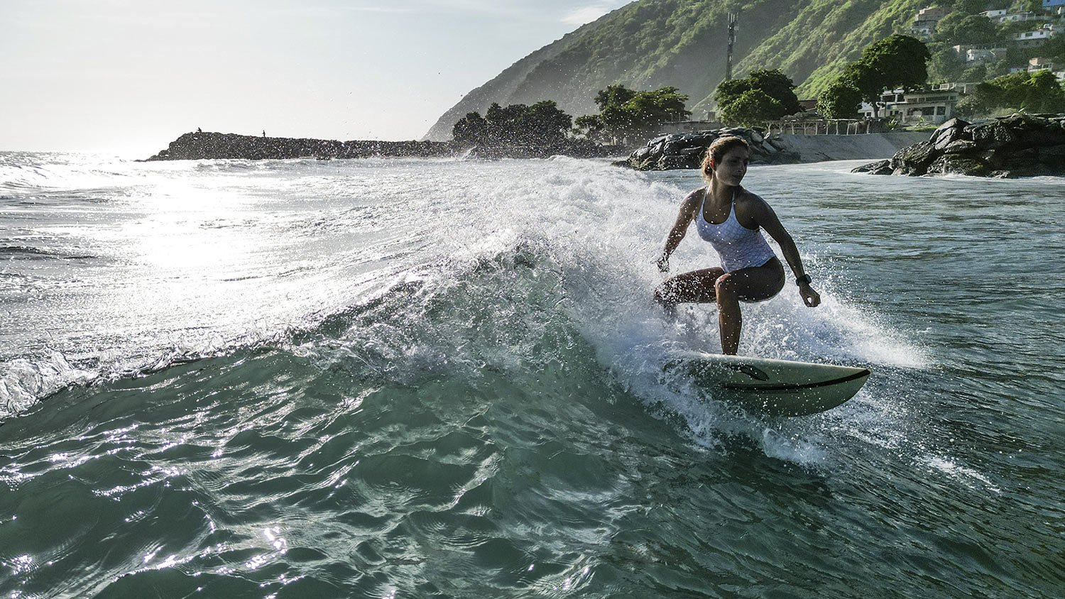  Diana Lander rides a wave as she surfs off Anare beach in La Guaira, Venezuela, Tuesday, July 18, 2023. (AP Photo/Matias Delacroix) 