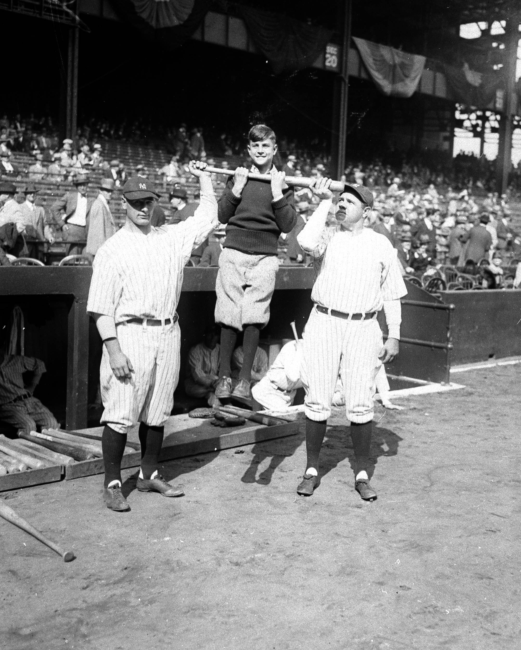  New York Yankees Lou Gehrig, left,  and Babe Ruth holding up Harold Baker as they create a chinning bar for the youth at Yankee Stadium in New York on October 7, 1927.  (AP Photo) 