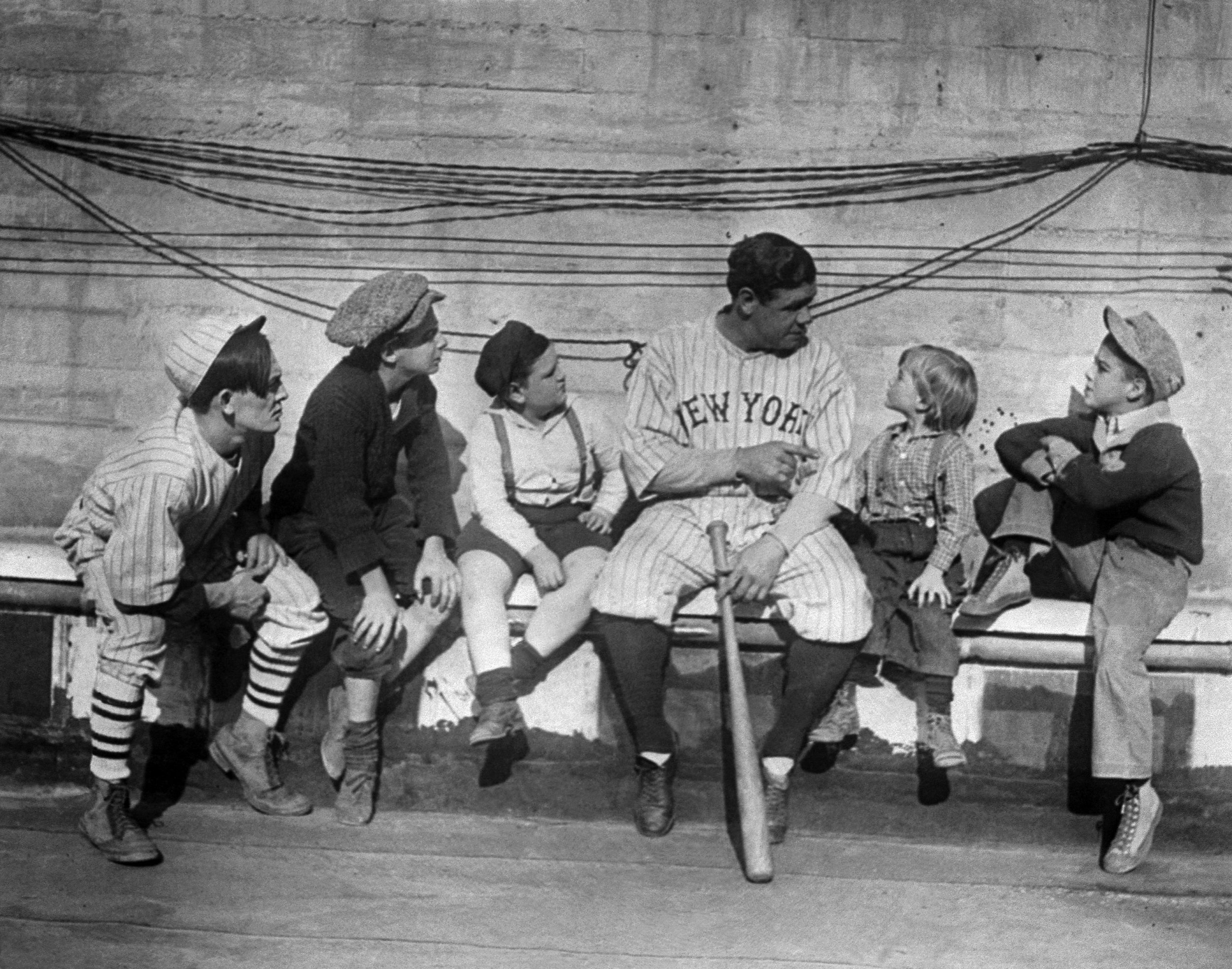  Youngsters lending an ear to Babe Ruth as he tells them stories of his life from orphanage to baseball fame, Nov. 29, 1924. (AP Photo) 