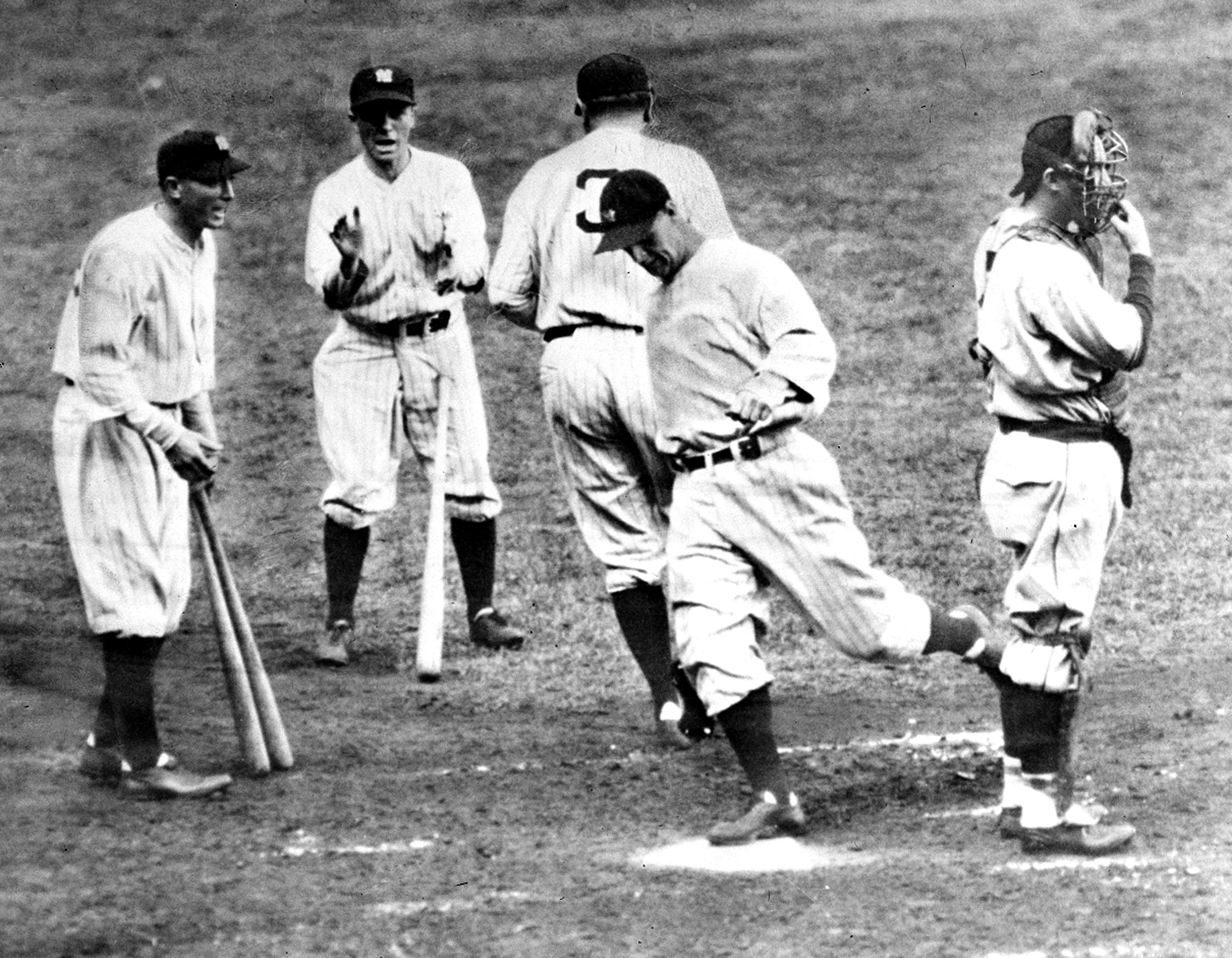  Lou Gehrig crosses home plate behind Babe Ruth, walking to dugout, after scoring the first home run of the 1932 World Series game with two on in the fourth inning at Yankee Stadium in New York City, Sept. 28.  The homerun gave the New York Yankees t