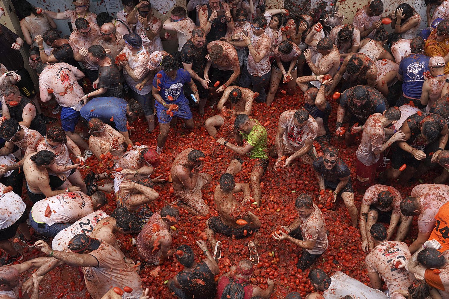  People pelt each other with overripe tomatoes, during the annual "Tomatina" festival, in Bunol, Spain, Wednesday, Aug. 30, 2023. (AP Photo/Alberto Saiz) 