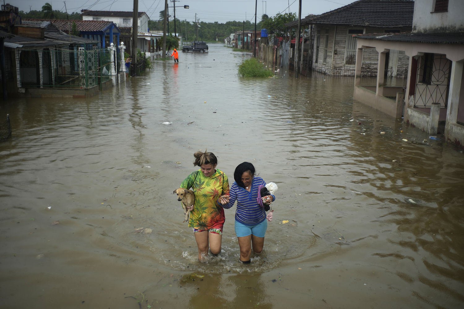  Residents wade through flood waters brought by Hurricane Idalia in Batabano, Cuba, Aug. 29, 2023. (AP Photo/Ramon Espinosa) 