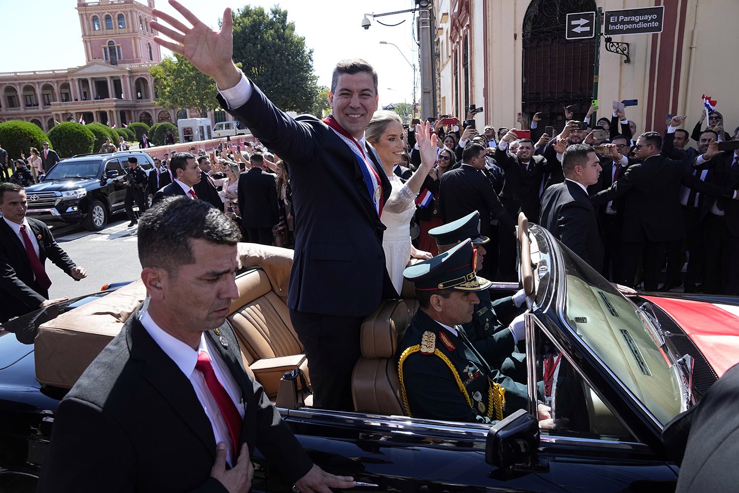  Paraguay's newly sworn-in President Santiago Pena and wife Leticia Ocampos wave on their way to the Cathedral on Pena's inauguration day in Asuncion, Paraguay, Aug. 15, 2023. (AP Photo/Jorge Saenz) 