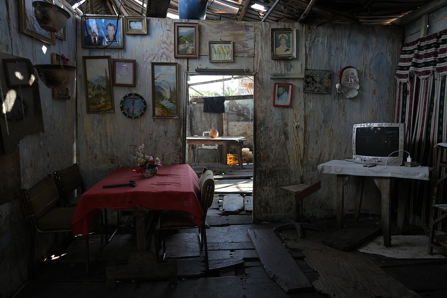  Family portraits and paintings adorn the walls of a stilt home that sits on the water's edge of Lake Maracaibo in the Santa Rosa de Agua neighborhood of Maracaibo, Venezuela, Aug. 8, 2023. (AP Photo/Ariana Cubillos) 