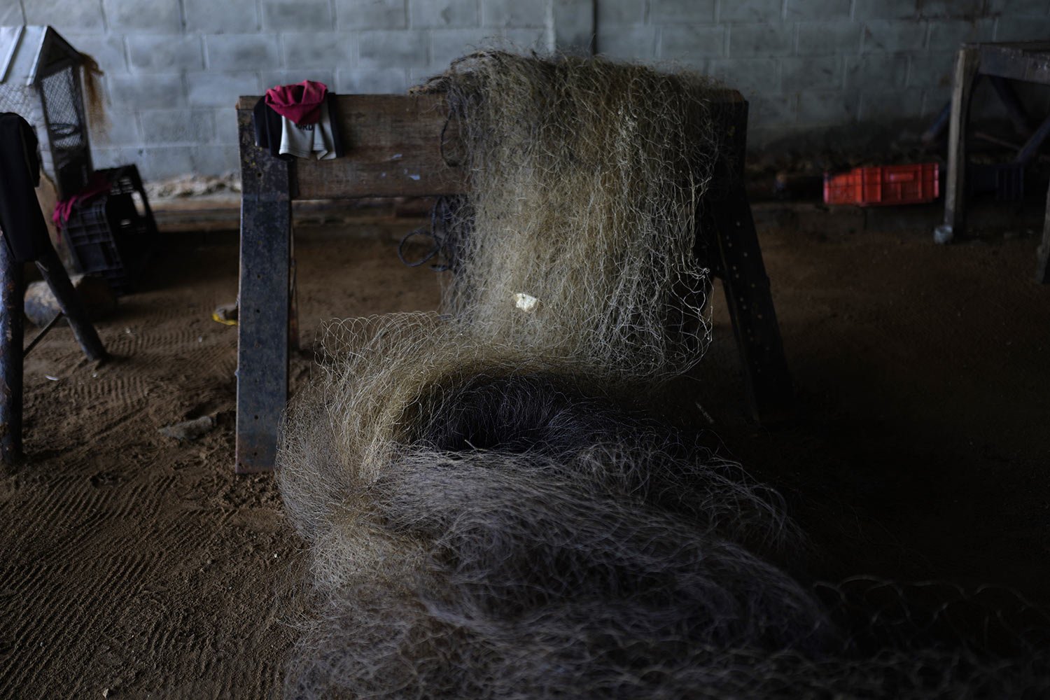  An oil-stained fishing net is stored in a home in San Francisco, Venezuela, Aug. 9, 2023. (AP Photo/Ariana Cubillos) 