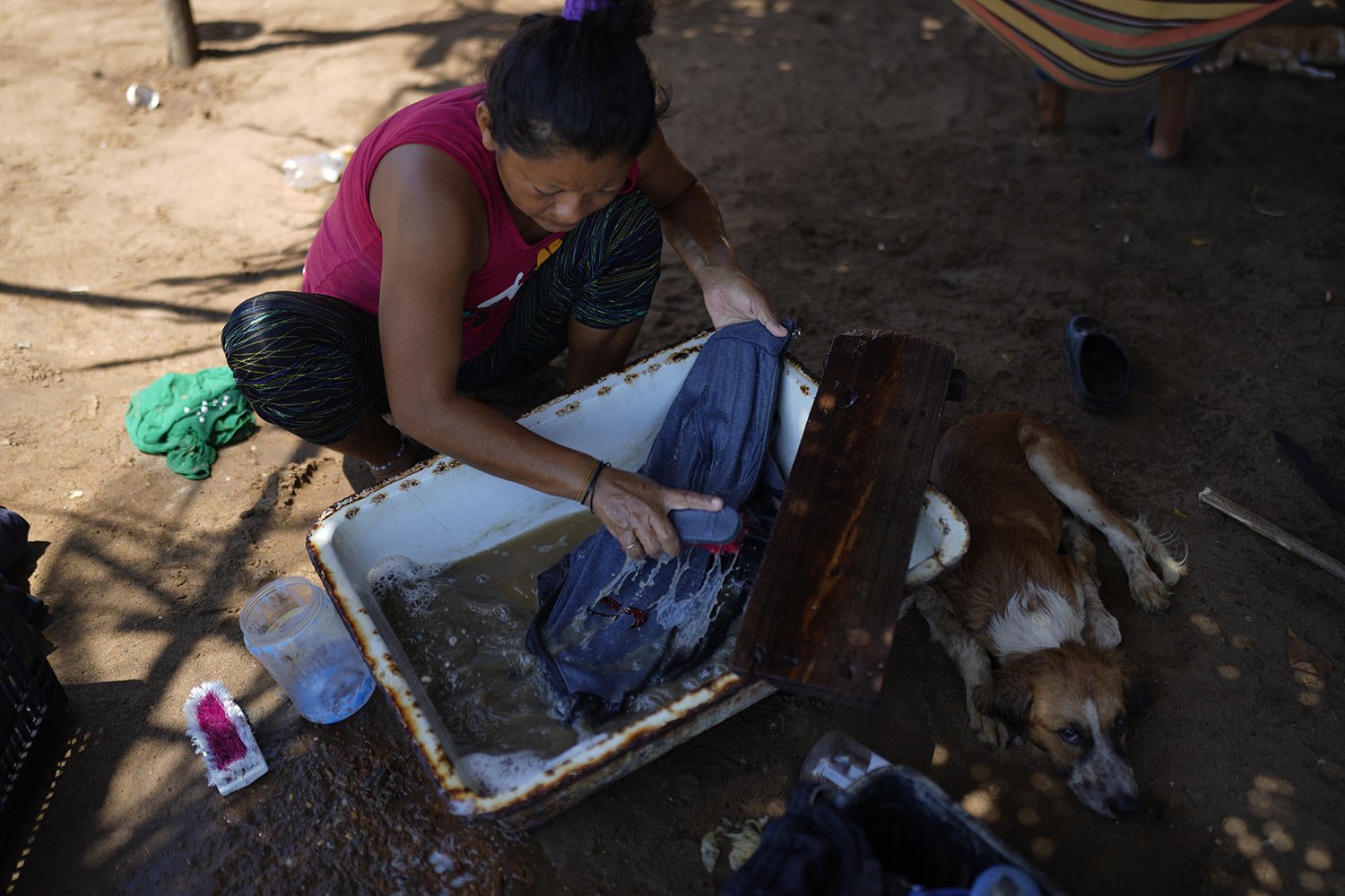  A woman hand washes her laundry with water from Lake Maracaibo in San Francisco, Venezuela, Aug. 9, 2023. (AP Photo/Ariana Cubillos) 