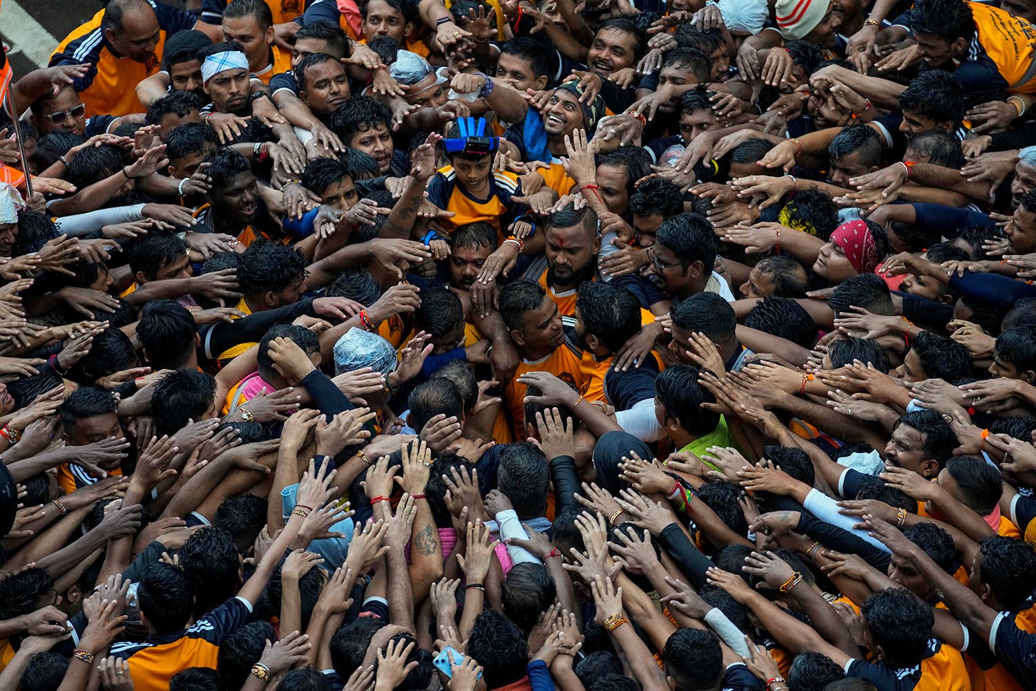  Revelers pay respect before forming human pyramids to reach an overhanging earthen pot while celebrating Hindu festival Janmashtami in Mumbai, India, Thursday, Sept. 7, 2023.  (AP Photo/Rajanish Kakade) 