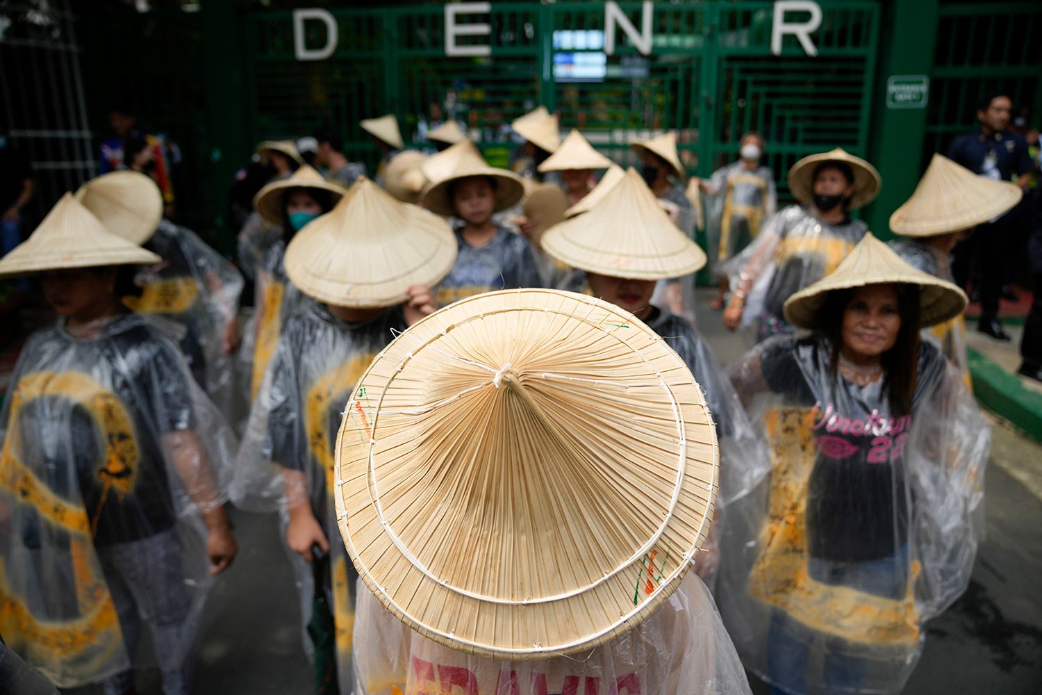  Protesters wear a traditional hat as they join the global march to end fossil fuel in front of the Department of Environment and Natural Resources on Friday, Sept. 15, 2023, in Quezon City, Philippines. (AP Photo/Aaron Favila) 