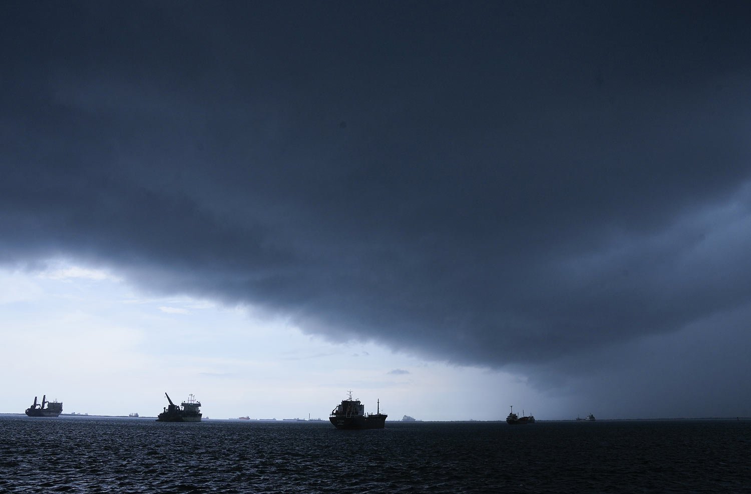  Storm clouds gather over cargo ships are anchored on Atlantic side of the Panama Canal as they wait to navigate through the canal, near Colon, Panama, Sept. 4, 2023. Authorities limited in August the number of ships passing through the canal in due 