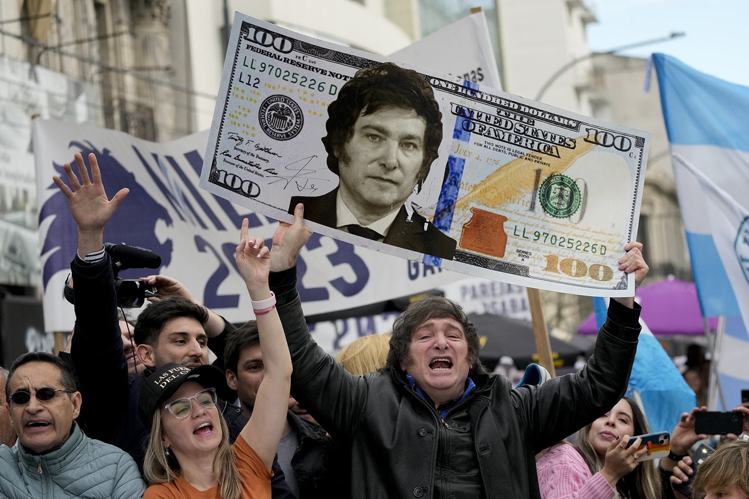 Presidential hopeful of the Liberty Advances coalition Javier Milei holds a giant cardboard U.S. dollar bill with his face on it at a campaign rally in La Plata, Argentina, Sept. 12, 2023. (AP Photo/Natacha Pisarenko) 