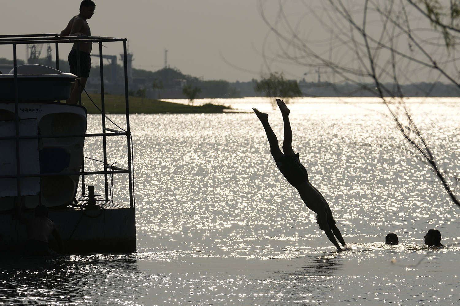  Youths cool off in the bay of Asuncion, Paraguay, Sept. 25, 2023. (AP Photo/Jorge Saenz) 