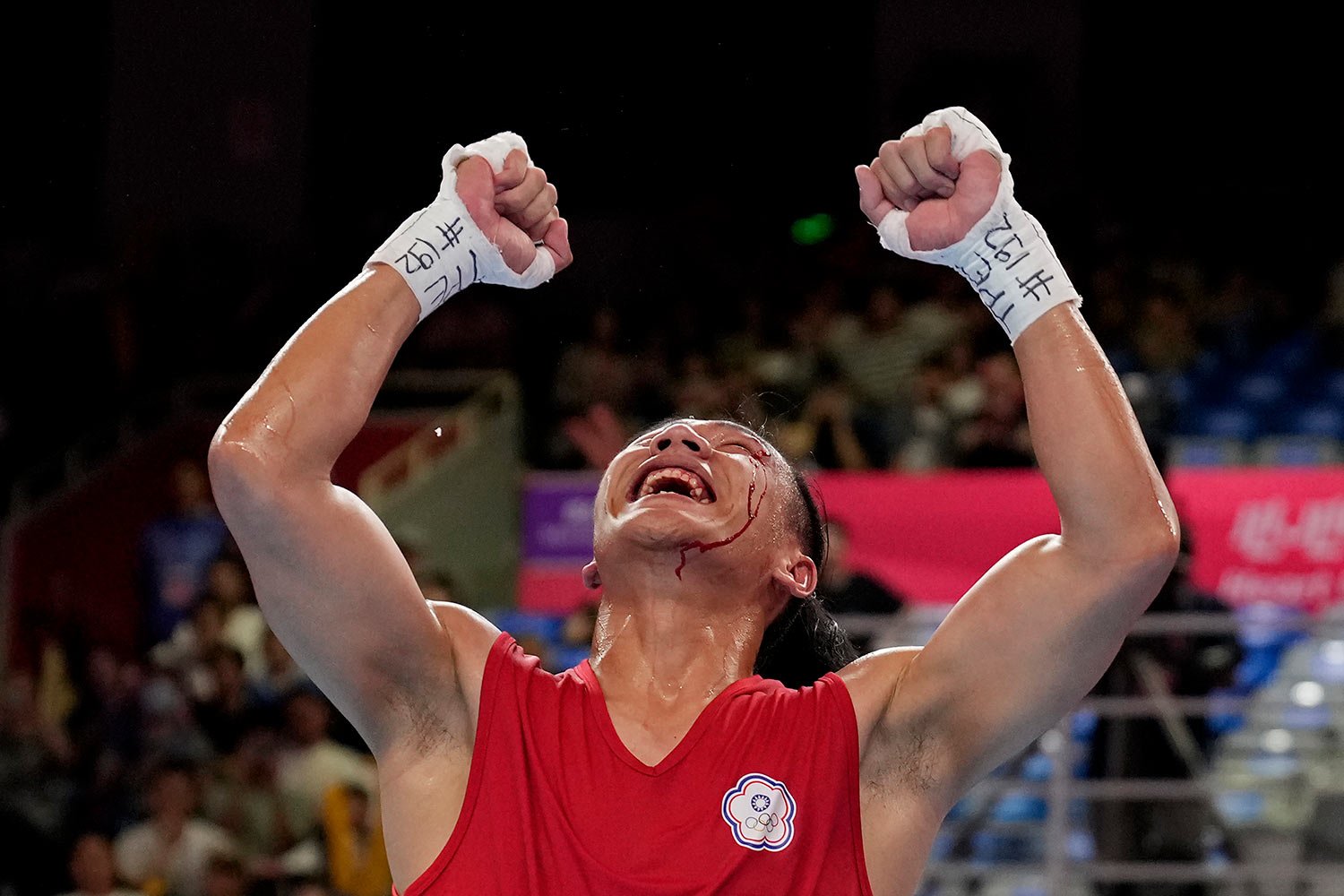  Taiwan's Kan Chia-Wei celebrates after defeating Turkmenistan's Bayramdurdy Nurmuhammedov during the men's 63.5-71kg semifinal boxing match at the 19th Asian Games in Hangzhou, China, Hangzhou, Tuesday, Oct. 3, 2023. (AP Photo/Aijaz Rahi) 
