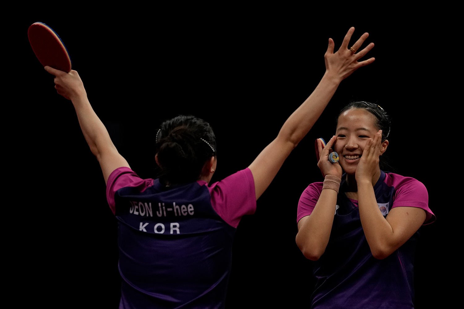  South Korea's Jeon Jihee, left and Shin Yubin celebrate after defeating North Korea in the Table Tennis Women's Doubles Final match for the 19th Asian Games in Hangzhou, Monday, Oct. 2, 2023. (AP Photo/Ng Han Guan) 