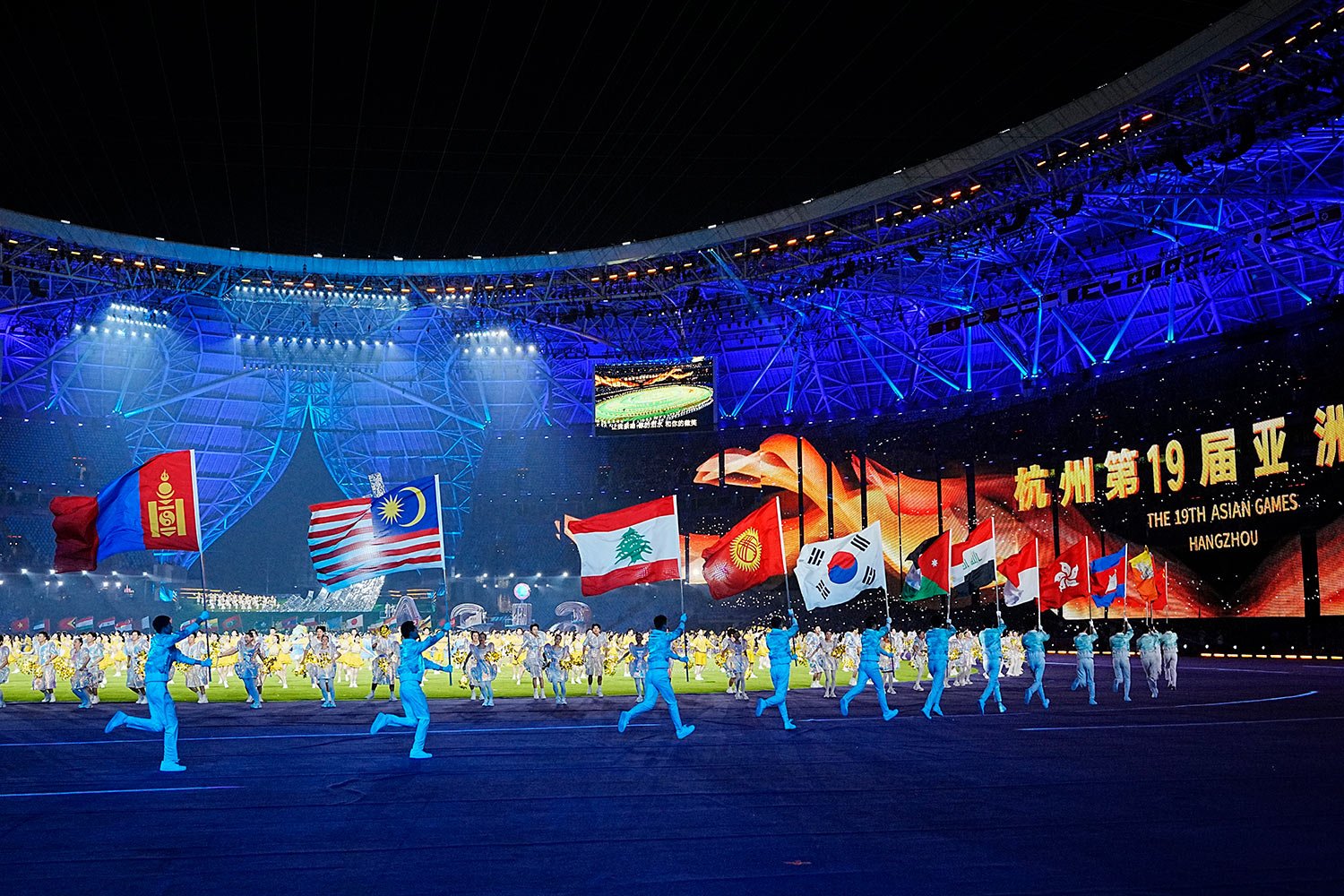  Flags of the participating countries are carried during the closing ceremony of the 19th Asian Games in Hangzhou, China, Sunday, Oct. 8, 2023. (AP Photo/Vincent Thian) 