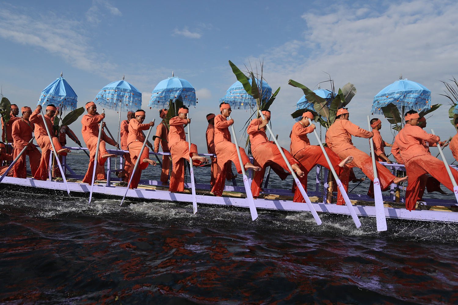  Inntha ethnic people row on a long boat in a procession carrying Buddha images to a monastery during the pagoda festival Thursday, Oct. 19, 2023, in Inlay Lake, southern Shan State, Myanmar. (AP Photo/Thein Zaw) 