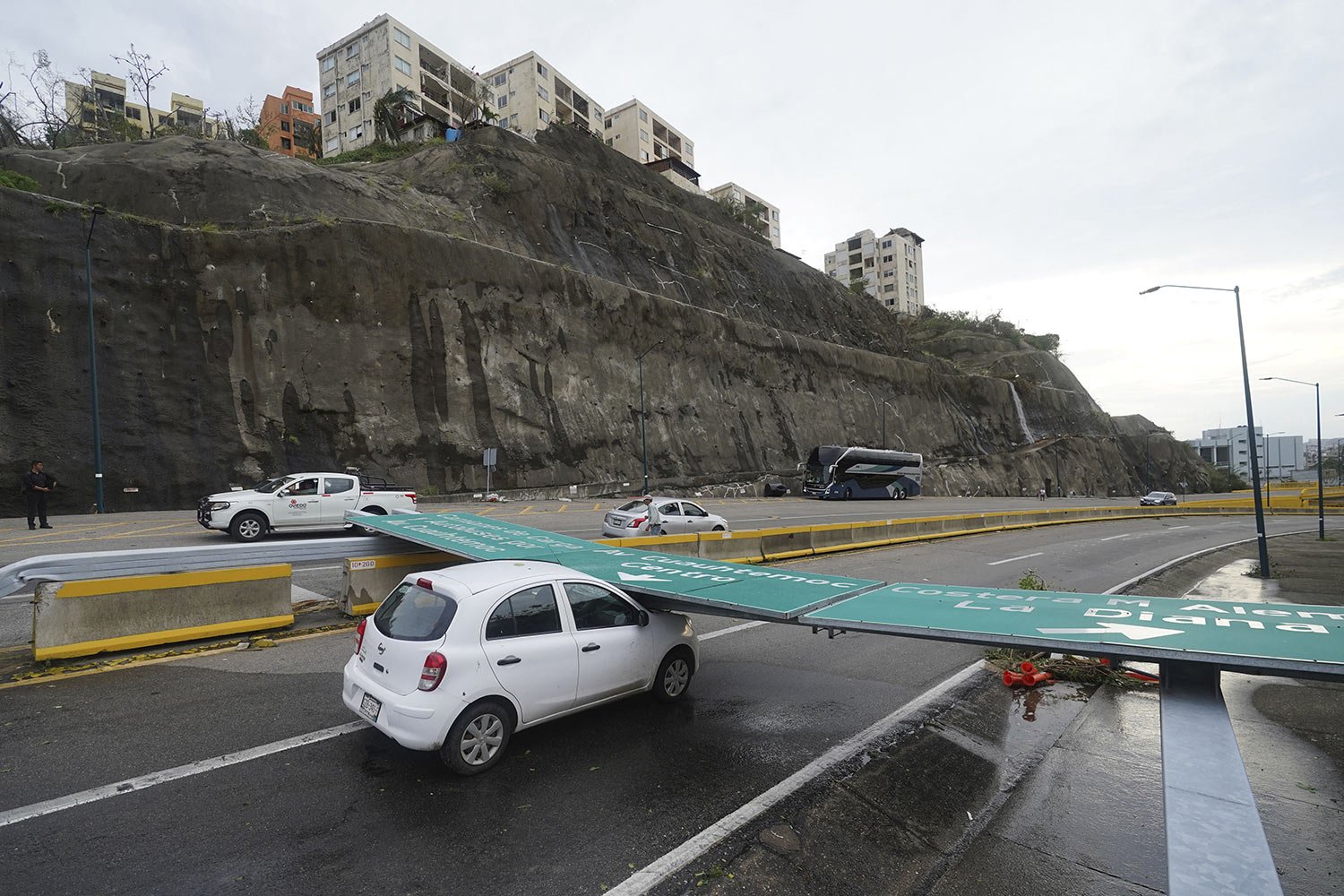  A traffic sign lays on a car after Hurricane Otis ripped through Acapulco, Mexico, Oct. 25, 2023. (AP Photo/Marco Ugarte) 