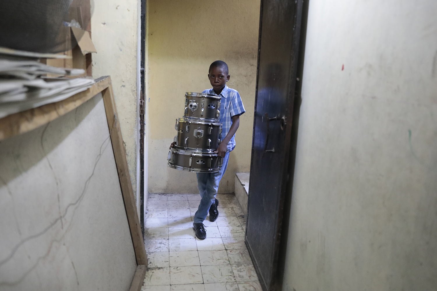  Woodberson Seide puts his drums away after a practice session at the Plezi Mizik Composition Futures School in Port-au-Prince, Haiti, Sept. 21, 2023. Woodberson Seide took his first lesson two years ago as part of the after-school music program foun