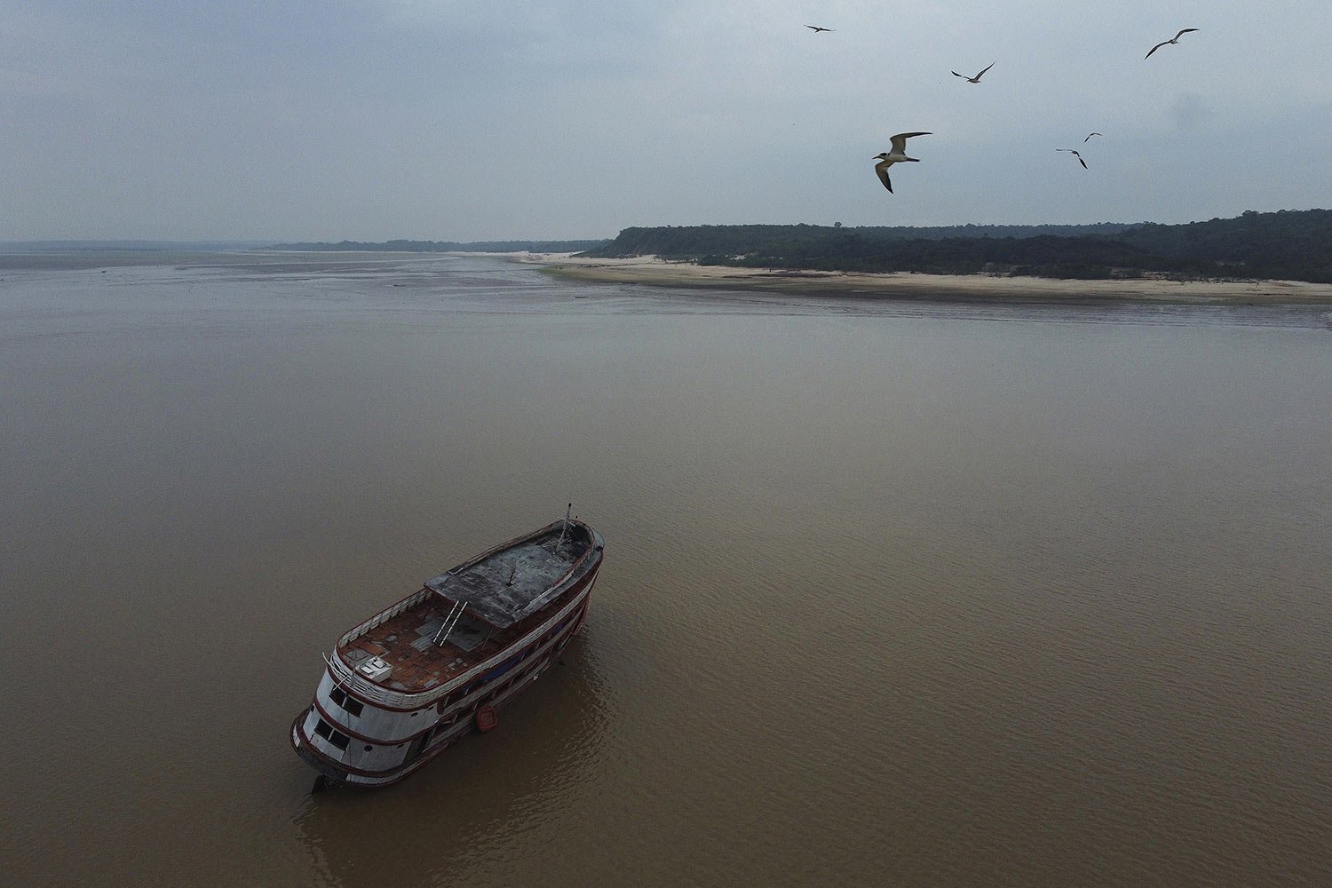  A boat is stuck in the low water levels of the Negro River during a drought in Manaus, Amazonas state, Brazil, Oct. 16, 2023. (AP Photo/Edmar Barros) 