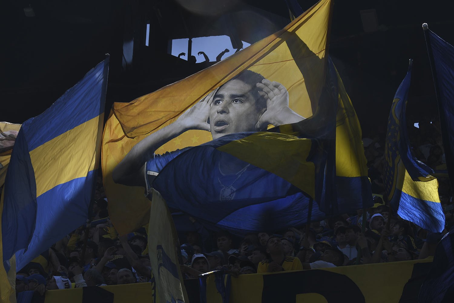  Fans of the Boca Juniors soccer team wave a flag featuring the club's Vice President Juan Ramon Riquelme, who is a former player with the team, during a local tournament soccer match with River Plate at La Bombonera stadium in Buenos Aires, Argentin