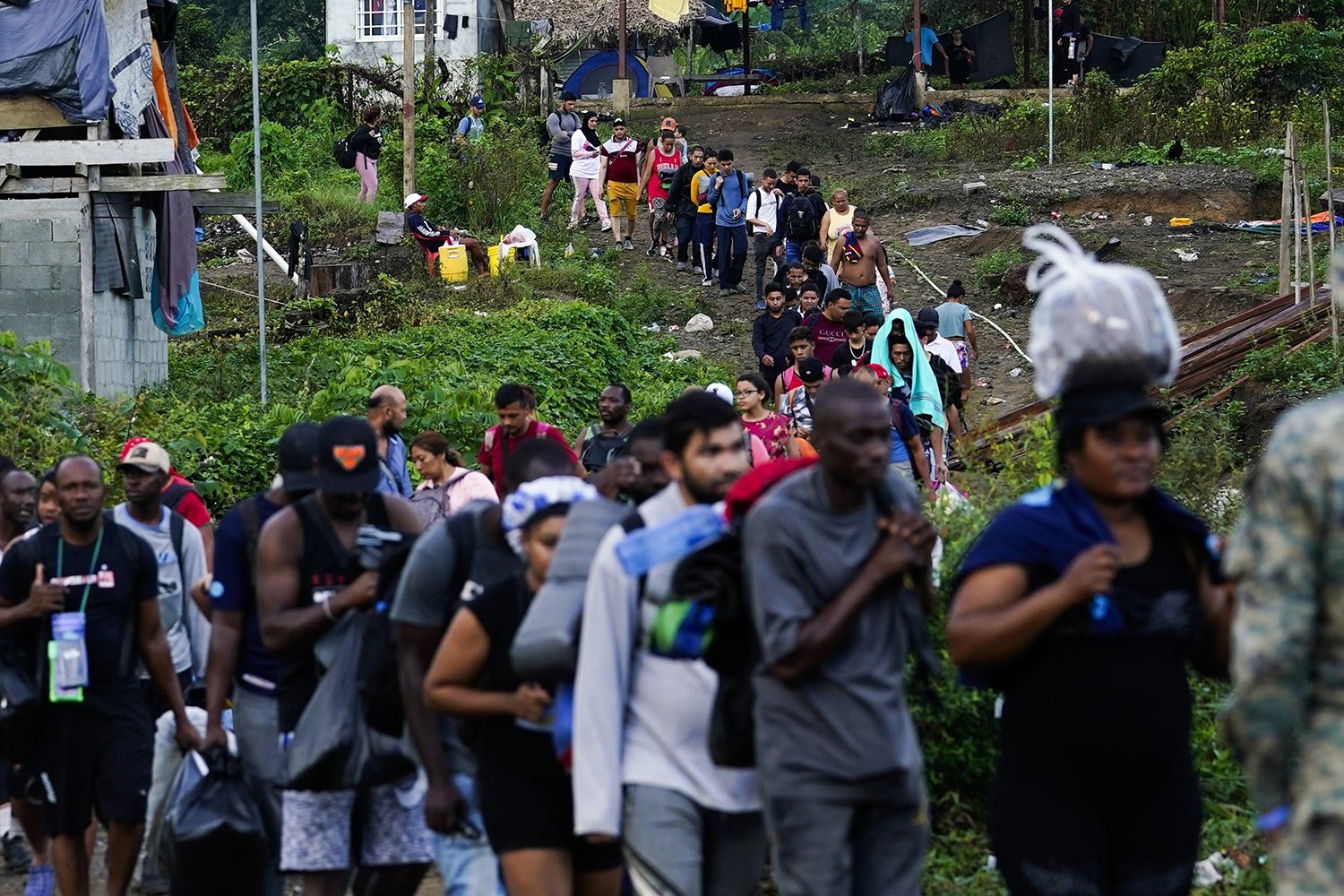  Migrants heading north line up to take a boat, in Bajo Chiquito, Darien province, Panama, Oct. 5, 2023, after walking across the Darien Gap from Colombia. (AP Photo/Arnulfo Franco) 